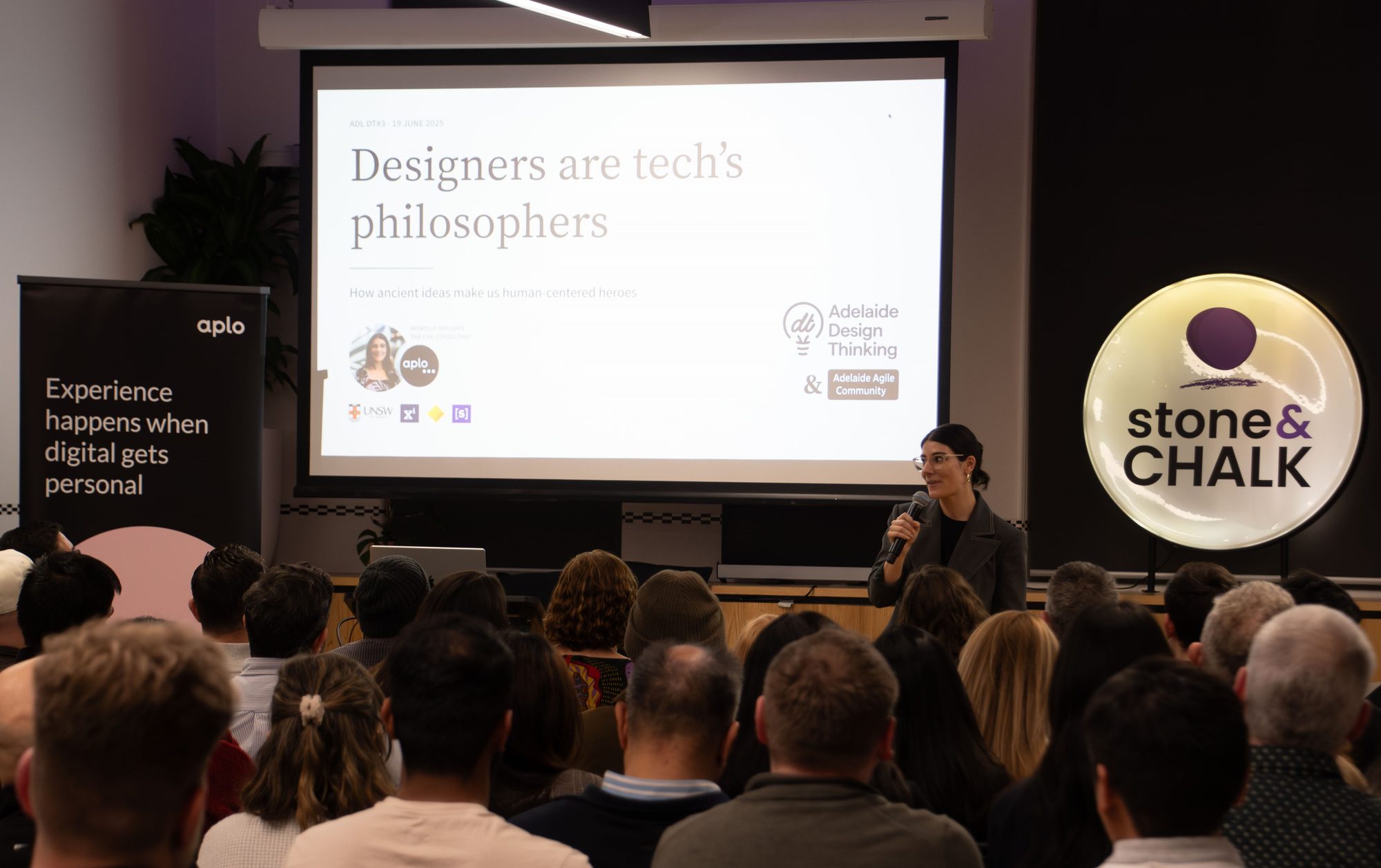 Monique Bettes presenting "Designers are tech's philosophers" on stage at ADL DT#3, hosted by Adelaide Design Thinking and the Adelaide Agile Community at Stone & Chalk, Adelaide.